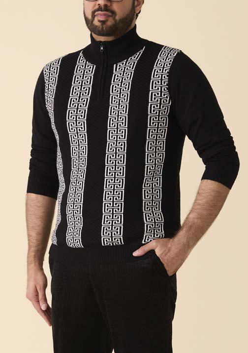 A man wears the Inserch Grecian Intarsia Half Zip Sweater SW615 in black, featuring a stand collar and white geometric vertical patterns, paired with black pants. Brand: Inserch.