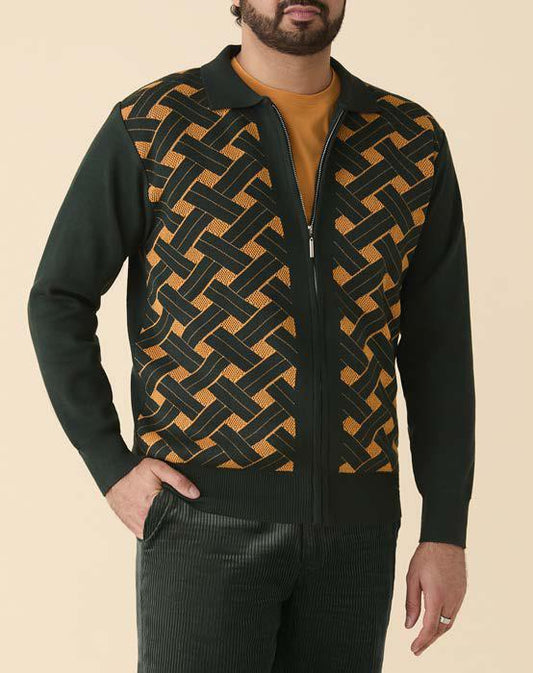 A man wears the Inserch Geometric Full Zip Sweater SW908-00021 in hunter green, featuring a woven geometric pattern on the front, paired with dark corduroy pants and a mustard-colored shirt.