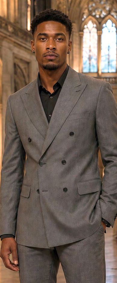 A man wearing a MANZINI DIEGO 2PC Tone on Tone Double Breasted Charcoal Tailored fit suit jacket over a black shirt.
