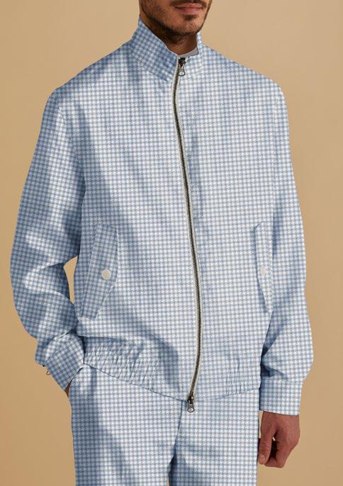 A person wearing the Inserch Linen Houndstooth Jacket JS269-00014 in light blue with coordinating pants. The ensemble features a modern 2-way zipper against a neutral beige background.
