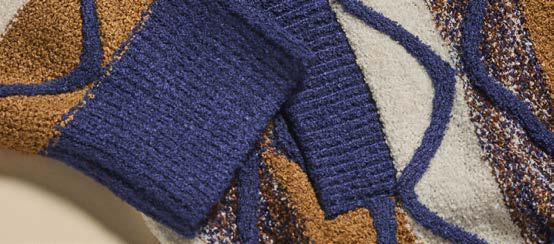 A person wears the Inserch Bouclé Yarn Graphic Full Zip Sweater SW614-00013 in royal blue, paired with a white turtleneck and brown corduroy pants, standing against a beige background. Brand: Inserch.