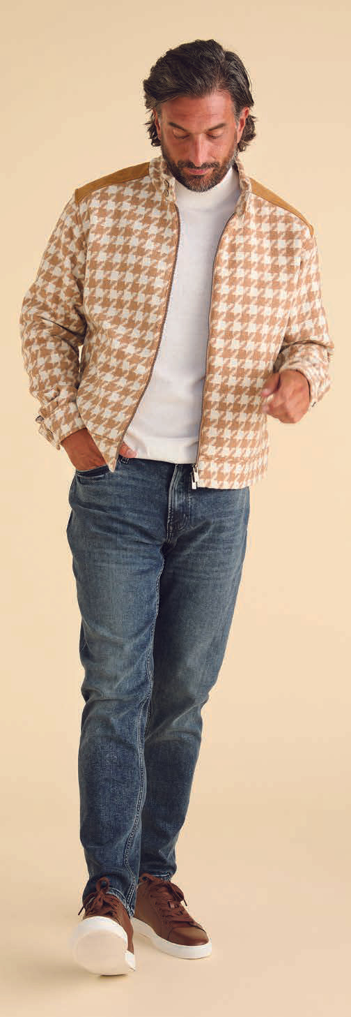 Someone is dressed in the Inserch Wool Blend Houndstooth Suit JS264B-09 Khaki, featuring a jacket and matching regular-fit pants. The outfit includes a high collar, shoulder patches, and a sleek 2-way zipper, set against a beige background.