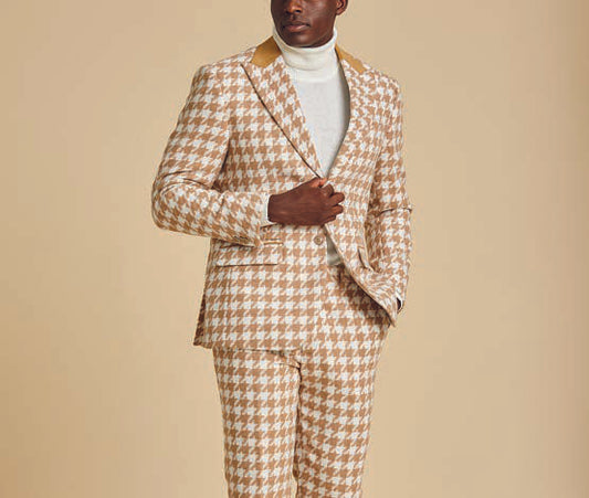 A man models the Inserch Houndstooth Suit BL264-09 Khaki by Inserch, paired with a white turtleneck, standing against a beige background and highlighting the suit's modern fit.