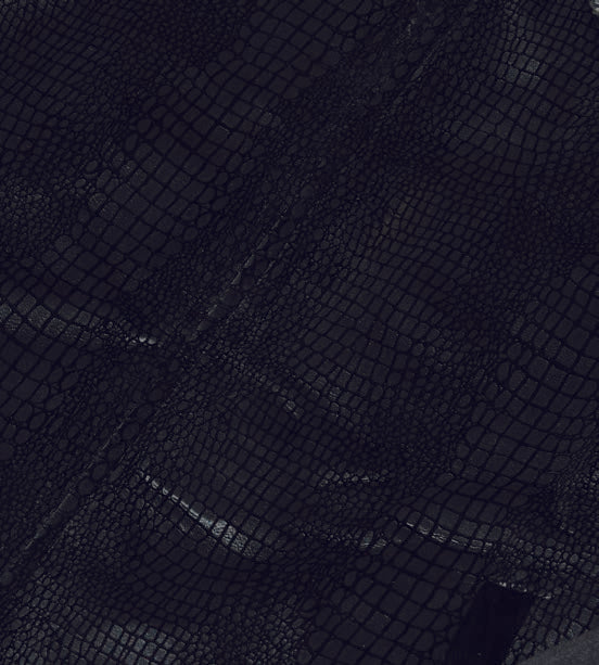 An individual clad in the Inserch Sueded Snake Skin Embossed Jacket Suit JS268-01 Black and regular-fit pants, complemented by white sneakers, stands against a plain beige backdrop.