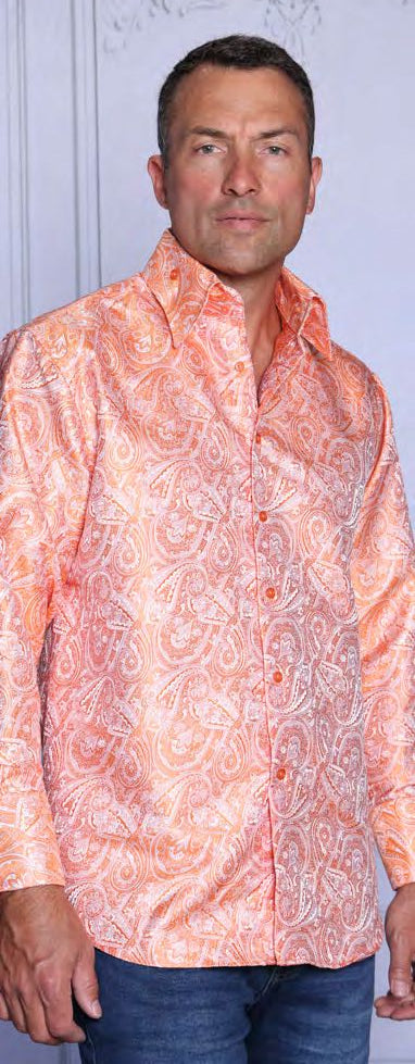 A man wearing the INSOMNIA MZT-210 Woven Satin Orange Shirt by Insomnia with blue jeans stands in front of a light-colored background.