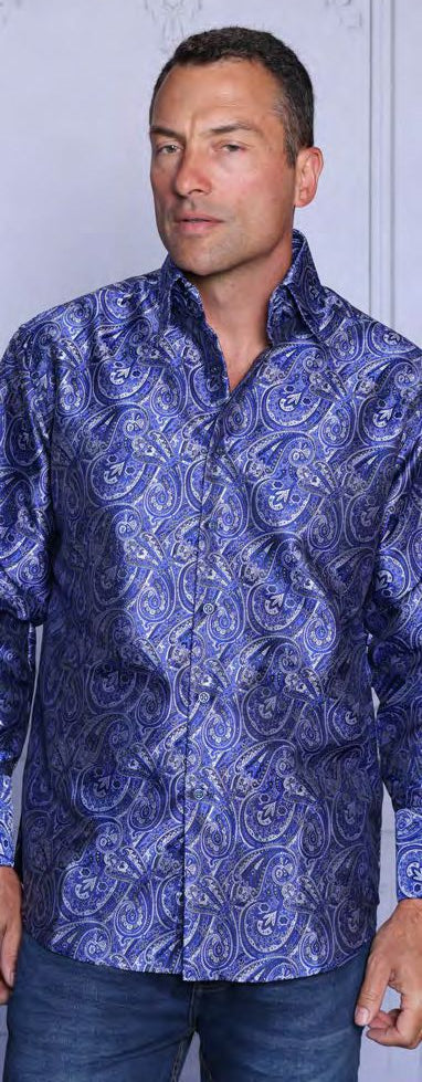 A man stands before a light-colored wall wearing the Insomnia INSOMNIA MZT-210 Woven Satin Blue Shirt, featuring a paisley pattern and French cuffs.
