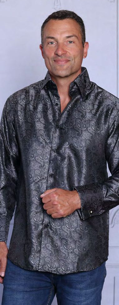 A man wearing the INSOMNIA MZT-206 Woven Satin Charcoal Shirt by Insomnia and blue jeans stands in front of a light background.
