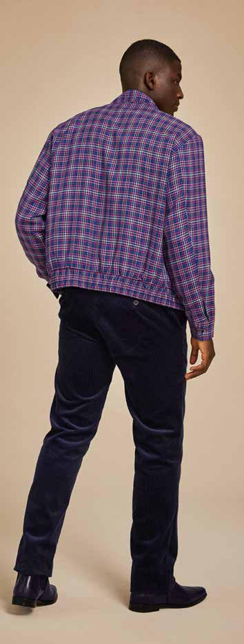 A man wearing the Inserch Micro Check Suit JS266-126 Purple, a stylish regular fit suit featuring a patterned blue and purple check design with a printed lining, smiles against a plain background.