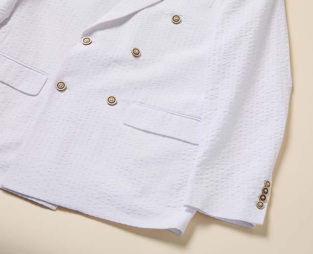 A man models the Inserch Double Breasted Seersucker Peak Lapel Blazer BL506-00002 in white over a light blue shirt, shown from mid-face to waist against a beige background.