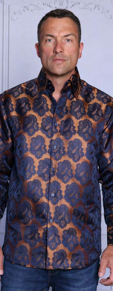 A man wears the INSOMNIA MZT-208 Woven Satin Bronze Shirt by Insomnia, featuring a shiny blue and bronze pattern with satin French cuffs, paired with blue jeans against a light background.