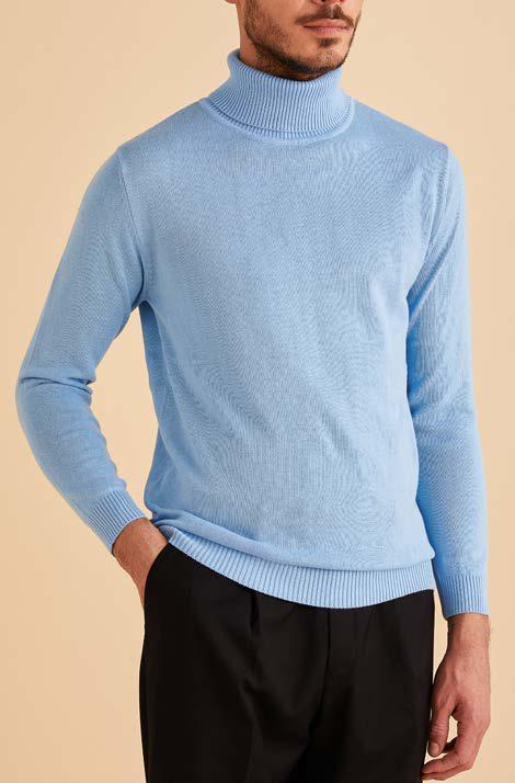 A bearded man smiles, wearing an Inserch Cotton Blend Slim Fit Turtleneck Sweater in Blue Mist, shown from shoulders to mid-chest.