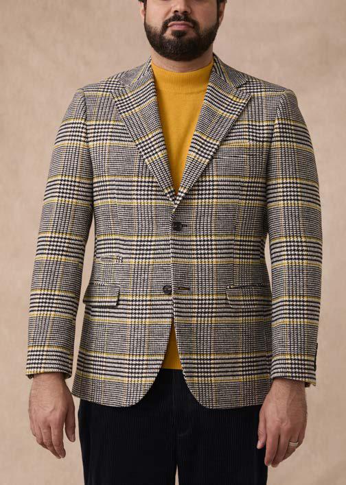 A man wearing a yellow turtleneck and an Inserch Glenn Check Wool Blend Blazer BL282-00041 in Black/White stands against a neutral background.