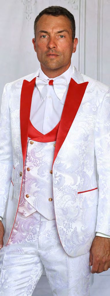 A man models the MANZINI ARMANI 3-Piece Slim Fit Fancy Woven White Red Suit by Manzini, featuring red lapels, a red vest, satin floral accents, and a white bow tie against a light background.