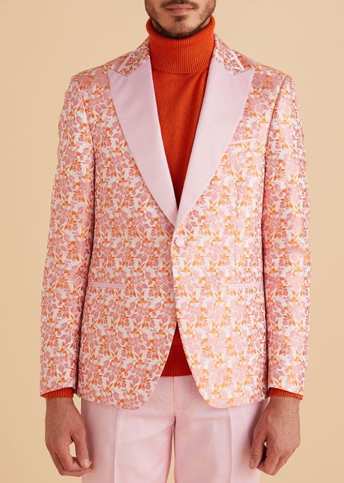 An Inserch Mini Floral Jacquard Peak Lapel Blazer BL203-62 in pink is layered over a matching pink turtleneck.