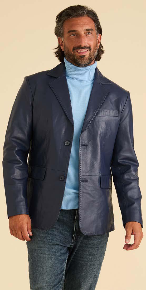 A man wearing the Inserch Leather Blazer 600-00011 Navy by Inserch—with paisley print lining—over a light blue turtleneck sweater and blue jeans, standing against a plain beige background.