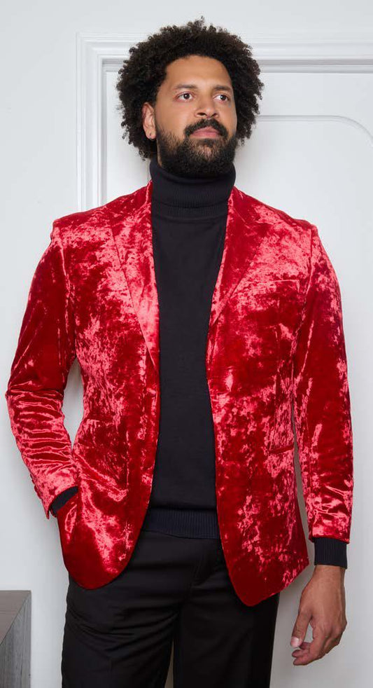 A man wearing the Inserch Crushed Velvet Blazer BL008-00030 in red over a black turtleneck and black pants stands in front of a white door, looking to the side.