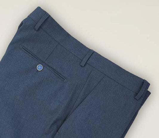 Close-up of the back of Inserch Denim Chino Pants P274-00010 Denim Blue, showcasing belt loops, a single welt pocket, and a blue button against a light background. These modern-fit pants by Inserch are crafted from a soft poly rayon blend for all-day comfort.
