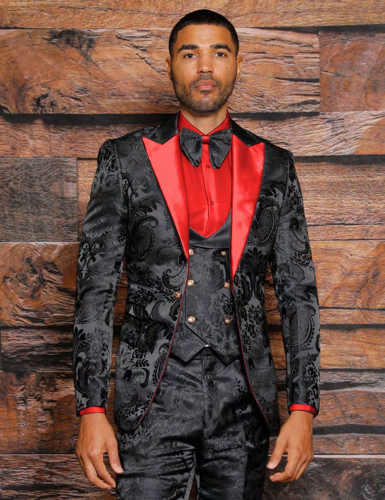 An individual clad in the INSOMNIA ARMANI Slim Fit Black Red Fancy Woven Suit from Insomnia, accessorized with a bow tie, poses against a wooden backdrop.