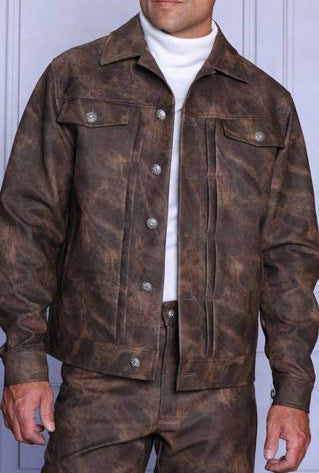 A man wearing the Insomnia INSOMNIA CHIVAS 2PC Stamped Concrete PU Casual Jacket & Pants Brown Set over a white turtleneck, standing indoors.