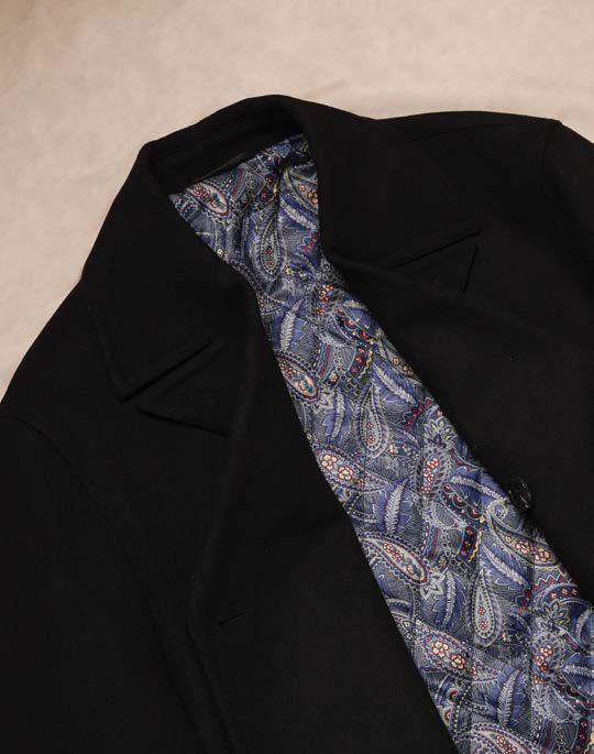 A man wearing the Inserch Wool Blend Peacoat JS558-00001 Black over a light gray turtleneck, standing against a plain beige background.