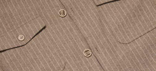 A man stands with one hand in his pocket against a plain background, wearing the Inserch Wool Blend Flannel Jacket JS280-00015 Stone—a regular-fit beige striped wool blend flannel jacket with marled buttons—over a brown shirt and cream pants.
