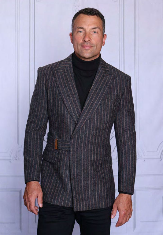 A man wearing the INSOMNIA MZW-702 Fancy Wool Blend Blazer by Insomnia and a black turtleneck stands in front of a light-paneled background.