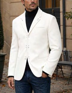 A man wears a Manzini MZW-502 Fancy Blazer White Tailored fit with metal stud accents, a black turtleneck, and blue jeans.