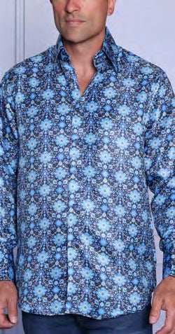 A man stands against a light background wearing the INSOMNIA MZT-203 Woven Satin Sky Shirt by Insomnia, featuring a blue geometric floral pattern and elegant French cuffs.