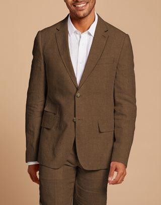 Dressed in an Inserch Slim Linen Blazer SU880-00064 Mocha, a man paired with a crisp white shirt stands against a beige background, showcasing effortless style and sophistication. The focus is on the modern cut of his attire, emphasizing only his upper body.