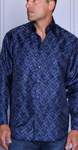 A man wears the Insomnia MZT-213 Woven Satin Navy Shirt—a long-sleeve, button-up shirt with a blue geometric pattern and French cuffs—paired with blue jeans, standing against a plain background.