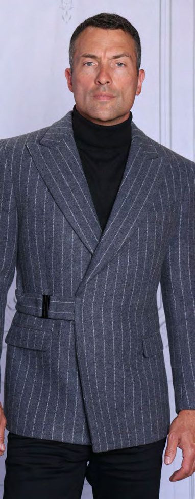 A man wears the Insomnia INSOMNIA MZW-703 Fancy Wool Blend Charcoal Blazer with a black turtleneck and black pants, standing against a light background.