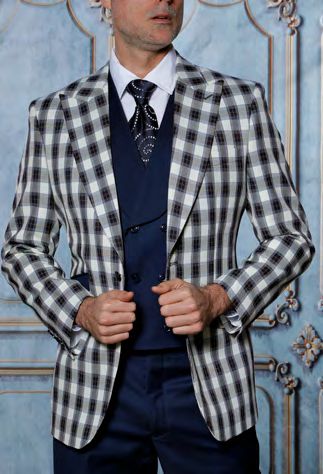 A man stands against an ornate blue background wearing the INSOMNIA PARIS-6 3PC Compose Tailored Fit Navy Suit by Insomnia.