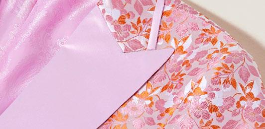 An Inserch Mini Floral Jacquard Peak Lapel Blazer BL203-62 in pink is layered over a matching pink turtleneck.