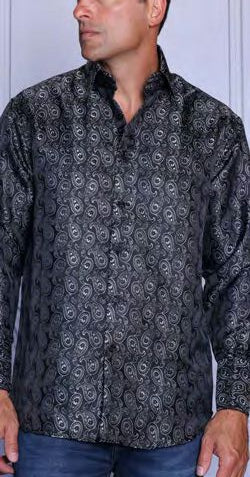 Man wearing the INSOMNIA MZT-207 Woven Satin Black Shirt by Insomnia, featuring a shiny paisley pattern and elegant French cuffs, stands against a plain background.