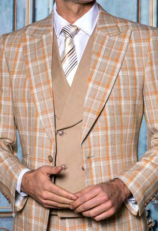 A man wears the INSOMNIA PARIS-5 3PC Compose Tailored Fit Taupe Suit by Insomnia, featuring a tailored taupe jacket with matching vest, over a white dress shirt and striped tie, posed against a blue patterned background.