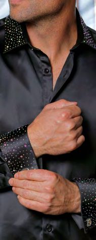 A man adjusts the french cuff of the INSOMNIA IN-118 Slim Fit Satin Stone Collar & Cuff Black Crystal Shirt by Insomnia, featuring sparkly embellishments on the collar and cuffs.