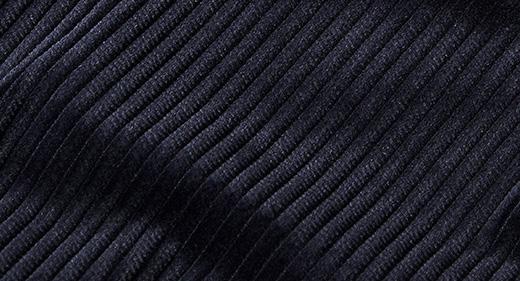 Close-up of Inserch Cotton Flat Front Corduroy Pants P3103-155 in Winter White, showcasing a ribbed fabric with diagonal lines that create a textured pattern, which is reminiscent of the sleek, modern fit seen in corduroy designs.