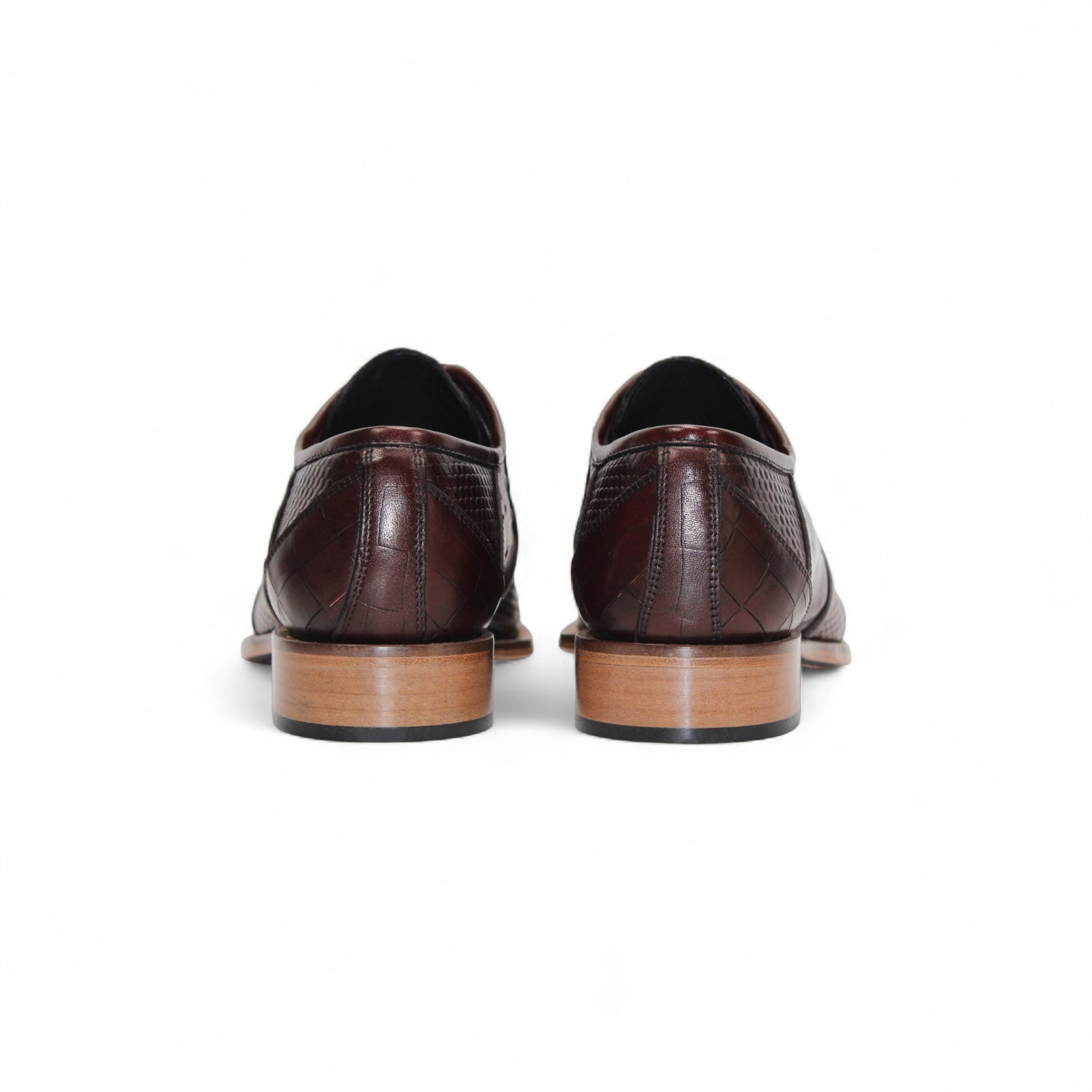The Duca Imperio Burgundy by Duca Di Matiste is a single genuine leather dress shoe in brown, featuring a textured design and light brown sole, displayed in profile against a white background for timeless style and comfort.