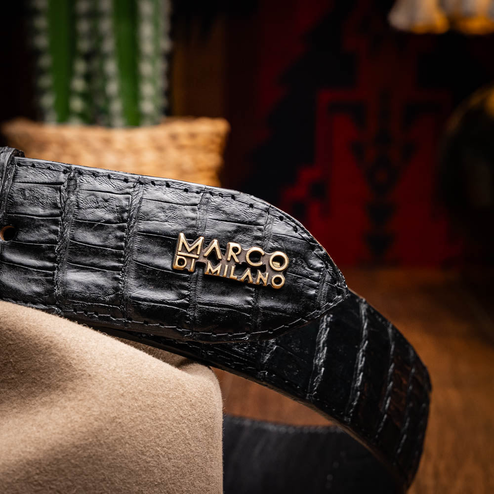 The Iowa Belt Black by Marco Di Milano is crafted from genuine black caiman skin with a crocodile texture, featuring a bold gold "MD" buckle and embossed branding—an eye-catching Western belt for any outfit.