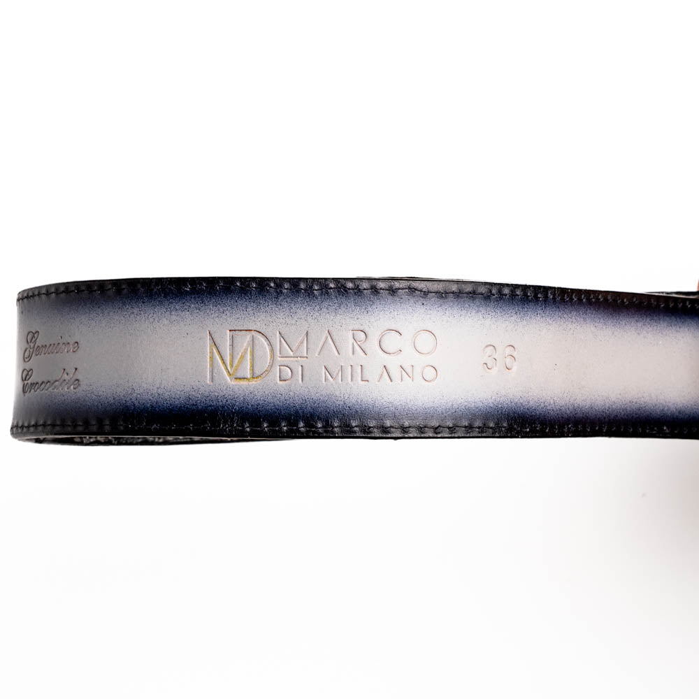 The Marco Di Milano Iowa Belt Stone Gray features genuine caiman skin and a bold gold "MD" buckle on a textured background, combining luxury with standout Western style.