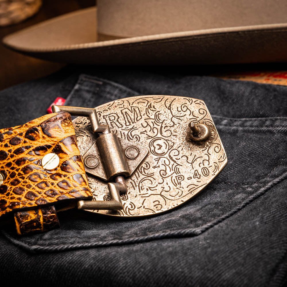 The Iowa Belt Mustard Brown by Marco Di Milano features genuine caiman crocodile leather and a bold gold "MD" buckle, elegantly displayed on a white background—showcasing the brand's signature luxury style.