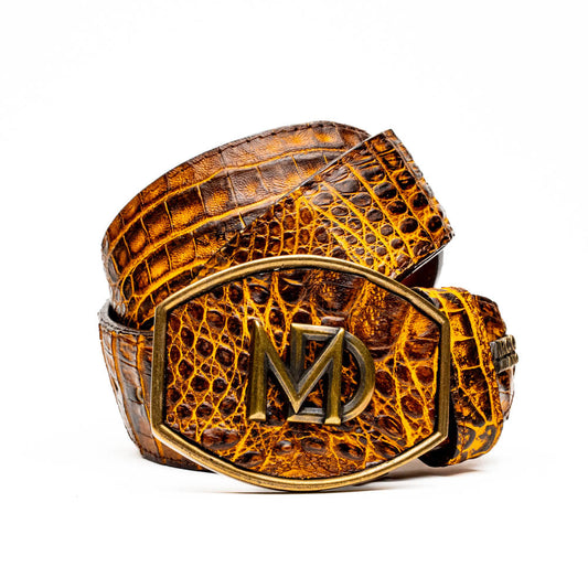 The Iowa Belt Mustard Brown by Marco Di Milano features genuine caiman crocodile leather and a bold gold "MD" buckle, elegantly displayed on a white background—showcasing the brand's signature luxury style.