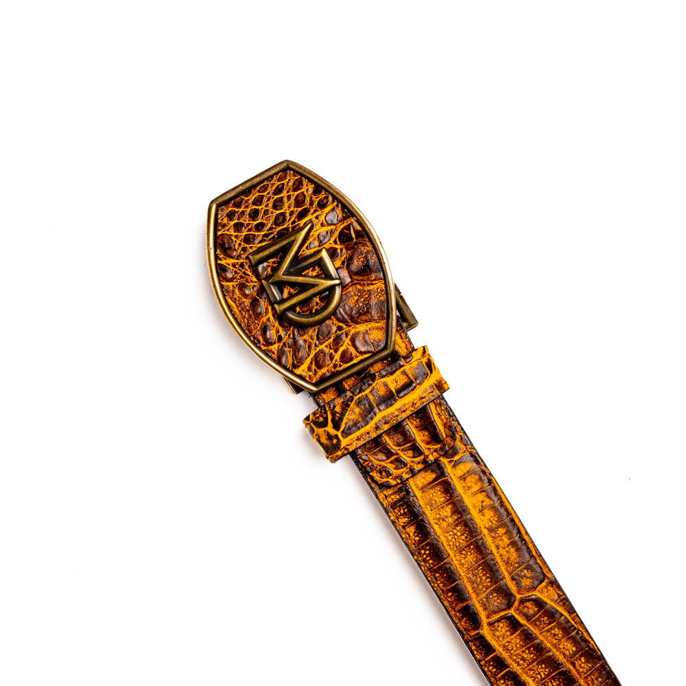 The Iowa Belt Mustard Brown by Marco Di Milano features genuine caiman crocodile leather and a bold gold "MD" buckle, elegantly displayed on a white background—showcasing the brand's signature luxury style.