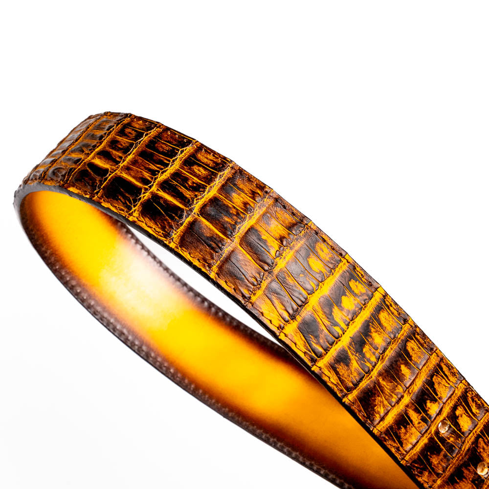 The Iowa Belt Mustard Brown by Marco Di Milano features genuine caiman crocodile leather and a bold gold "MD" buckle, elegantly displayed on a white background—showcasing the brand's signature luxury style.