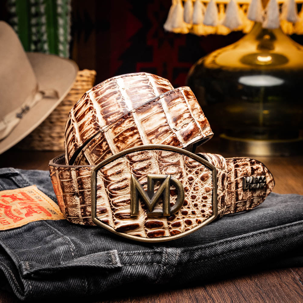 The Iowa Belt Stone Orix by Marco Di Milano features brown genuine crocodile leather, a gold "MD" buckle, and "Marco Di Milano" branding on the strap.
