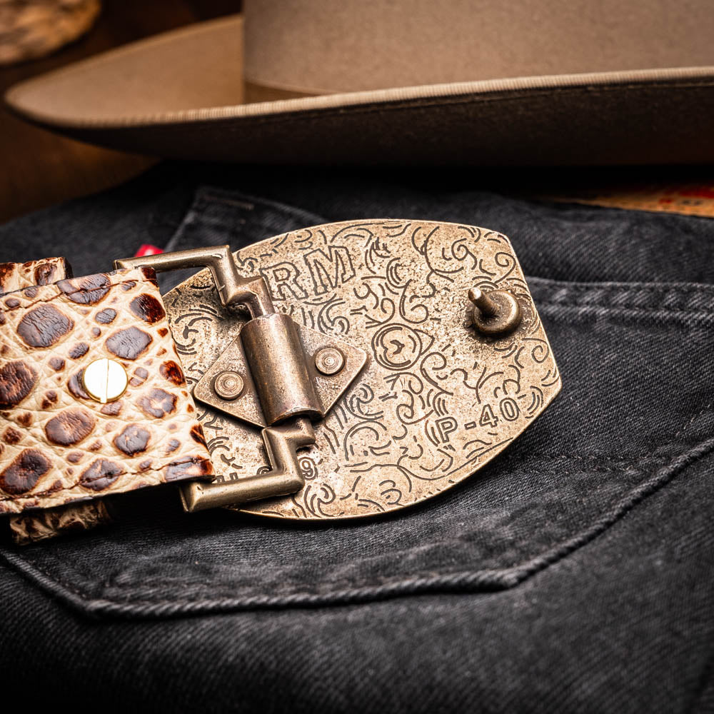 The Iowa Belt Stone Orix by Marco Di Milano features brown genuine crocodile leather, a gold "MD" buckle, and "Marco Di Milano" branding on the strap.