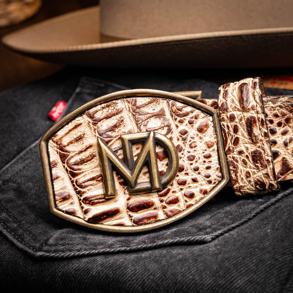 The Iowa Belt Stone Orix by Marco Di Milano features brown genuine crocodile leather, a gold "MD" buckle, and "Marco Di Milano" branding on the strap.