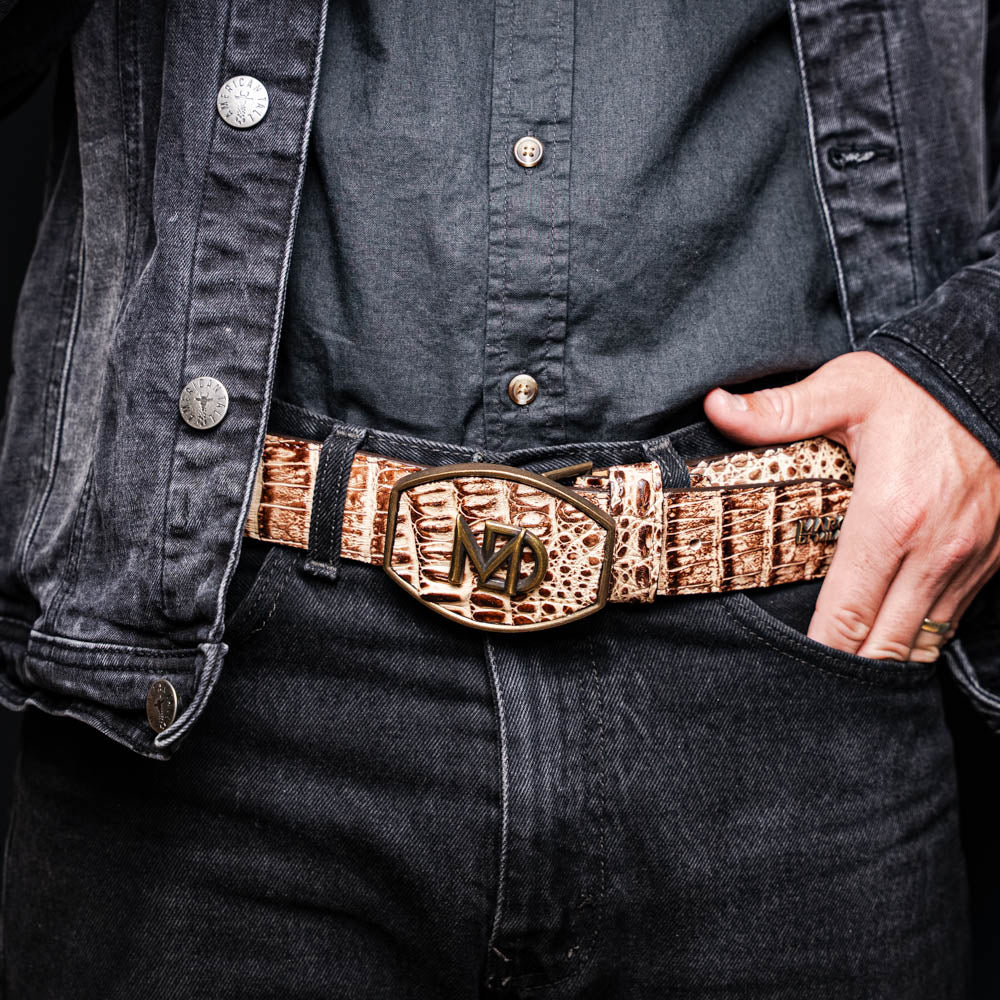 The Iowa Belt Stone Orix by Marco Di Milano features brown genuine crocodile leather, a gold "MD" buckle, and "Marco Di Milano" branding on the strap.