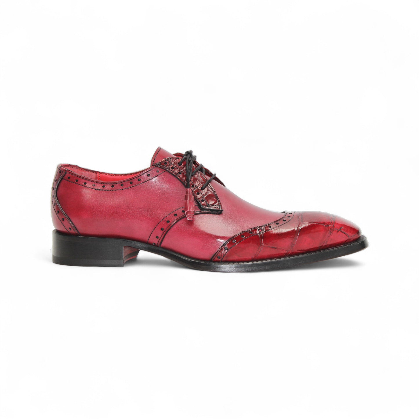 The Fennix Jax Antique Red by Fennix of Italy is a men's red leather dress shoe featuring decorative perforations, black laces, and a low black heel, exemplifying Italian craftsmanship and luxury on a white background.