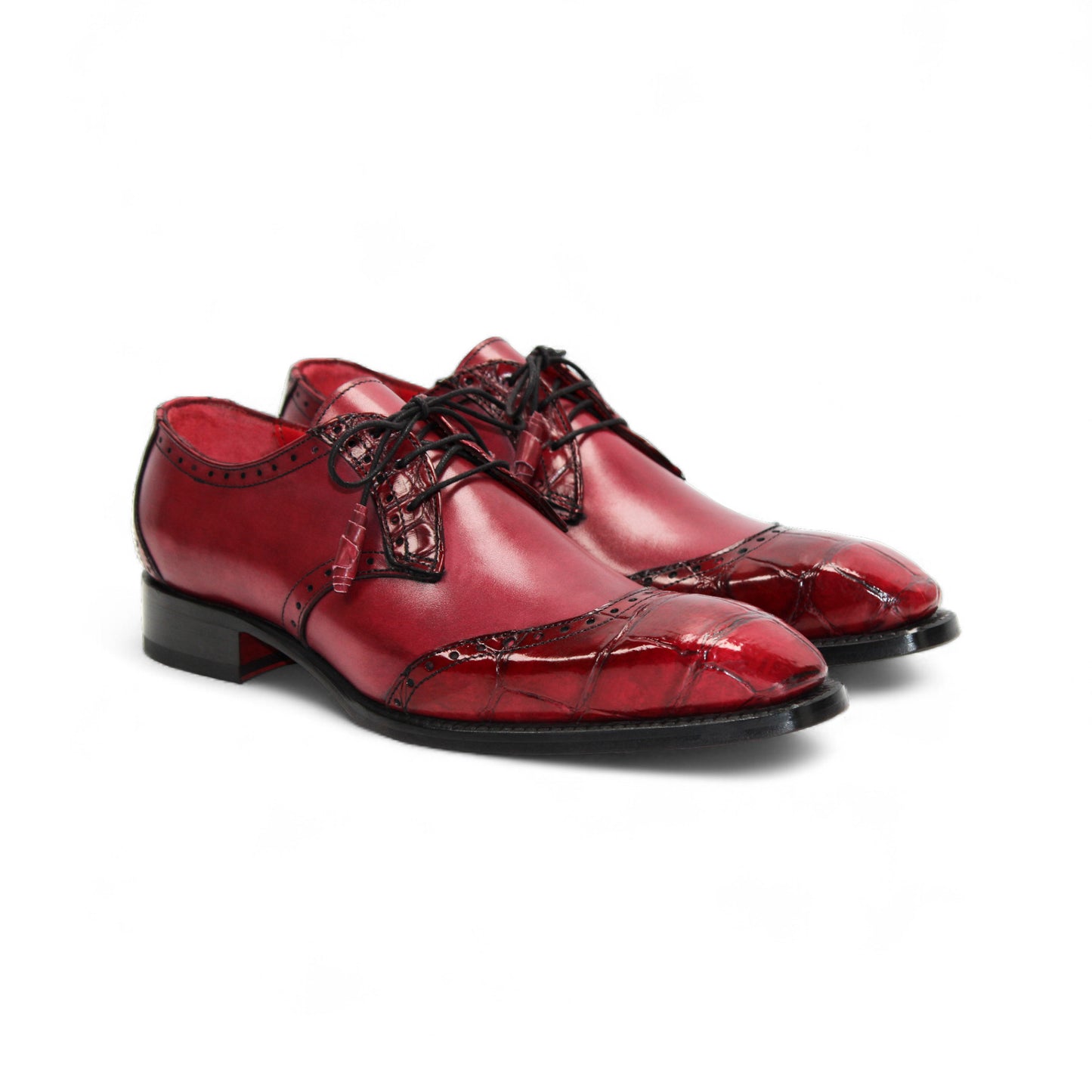 The Fennix Jax Antique Red by Fennix of Italy is a men's red leather dress shoe featuring decorative perforations, black laces, and a low black heel, exemplifying Italian craftsmanship and luxury on a white background.